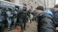 Riot police officers clash with pro-European Union activists near the entrance of city hall in Kiev, Ukraine, on Wednesday