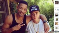 Justin Bieber posing with Will Smith