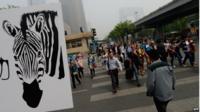 People cross the road in Beijing, May 2013