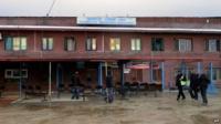 Nepalese men outside the dilapidated domestic terminal building in Kathmandu
