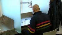A heroin users prepares his fix in a Danish 'consumption room'