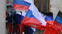 Pro-Russian activists hoist Russian flags over an administrative office in Donetsk, Ukraine, on 1 March 2014