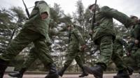 Pro-Russian armed forces march in Simferopol, Crimea. 8 March 2014