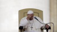File photo: Pope Francis touches his forehead after delivering his message during the general audience in St. Peter's Square, at the Vatican, 9 April 2014