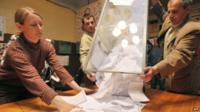 Ballot papers being emptied onto table