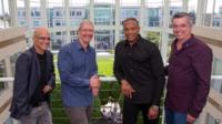 In this image provided by Apple, from left to right, music entrepreneur and Beats co-founder Jimmy Iovine, Apple CEO Tim Cook, Beats co-founder Dr. Dre, and Apple senior vice president Eddy Cue pose together at Apple headquarters in Cupertino, Calif.,
