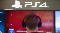 Man looking at Sony's PS4 consoles