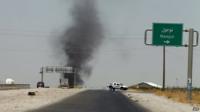 Smoke billows from an area controlled by the Islamic State of Iraq and the Levant (Isis) between the Iraqi towns of Naojul and Tuz Khurmatu