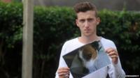 Nicholas Murphy holding a picture of his dog