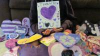 A girl holds a thank you poster in Waukesha, Wisconsin, on 19 June 2014