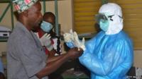 Health workers in protective suits.