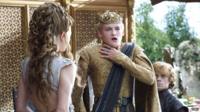 Joffrey in Game of Thrones holding his neck