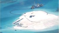 In this 25 Feb 2014 file photo taken by surveillance planes and released 15 May by the Philippine Department of Foreign Affairs, a Chinese vessel, top centre, is used to expand structures and land on the Johnson Reef, called Mabini by the Philippines and Chigua by China, at the Spratly Islands in the South China Sea, Philippines.