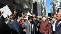 Narendra Modi (right) walks the streets of Manhattan