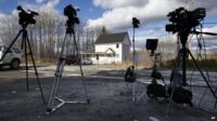 Television cameras stand on the road across from the house of nurse Kaci Hickox in Fort Kent, Maine 30 October 2014