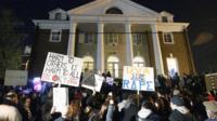 File photo: Protesters gather outside the fraternity house where an alleged gang rape took place