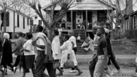 Marchers on the way to Montgomery as families watch from their porches, 1965.