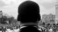 Stephen Somerstein, Dr. Martin Luther King, Jr. Looks out at crowd in Montgomery, 1965.