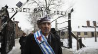 Survivors walk out of the gate at Auschwitz, 27 January 2015