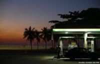 A worker prepares to fill a car at a gas station close to Copacabana beach in Rio de Janeiro