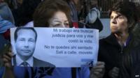 A woman holds a sign during the funeral of prosecutor Alberto Nisman, January 29, 2015.
