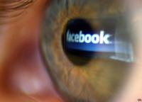 Eye with Facebook logo reflected in it