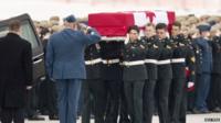 Honor guards carry the coffin of Sergeant Andrew Joseph Doiron to a hearse at CFB Trenton 10 March 2015