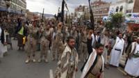 Shia rebels, known as Houthis, hold up their weapons to protest against Saudi-led airstrikes, as they chant slogans during a rally in Sanaa, Yemen