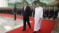 Chinese President Xi Jinping (L) accompanies Sri Lankan President Maithripala Sirisena