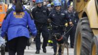 A search dog arrives at the site of a building collapse in the East Village neighborhood of New York, Friday, March 27, 2015