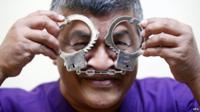 Malaysian political cartoonist Zulkiflee Anwar Haque, or "Zunar", reacts with mock handcuffs during his case at Duta Court, in Kuala Lumpur, 03 April 2015