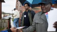 Ferguson City Council ward three candidates Lee Smith (R) and Wesley Bell (L) hand out election information during the municipal elections