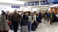 Passengers queuing at a check-in desk at Orly airport,