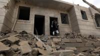 A Yemeni man inspects a house destroyed by an airstrike of the Saudi-led alliance which targeted a Houthi supporters-dominated neighbourhood in Sana'a, Yemen, 08 April 2015