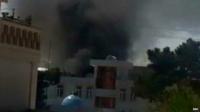 Smoke billows from the Balkh province court complex following an attack by gunmen