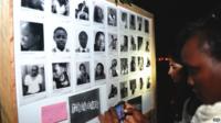 woman pays tribute at Freedom Corner in Uhuru Park in Nairobi on April 7, 2015 during a candlelight vigil to the victims of an attack claimed by Somalia"s Al-Qaeda-linked Shebab insurgents on a university campus in Kenya"s northern town of Garissa