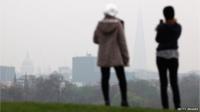 Bystanders overlook the London smog