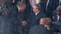 US President Barack Obama (L) shakes hands with Cuban President Raul Castro during the official memorial service for former South African President Nelson Mandela
