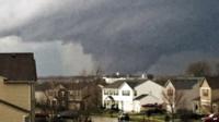 A tornado is viewed near Pearl Street from a home in the Kennedy"s subdivision in Kirkland, Ill., on Thursday, April 9, 2015.