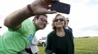 Former US Secretary of State Hillary Clinton poses for a photo with a supporter at the 37th Harkin Steak Fry in Indianola, Iowa in this 14 September 2014