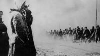 Soviet soldiers are marched into captivity, watched by weeping women