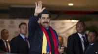 Venezuela's President Nicolas Maduro waves to photographers as he arrives to a hotel in Panama City, Friday, 10 April 2015.