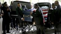 The casket of Walter Scott is removed from a hearse for his funeral at the Ministries Christian Centre on 11 April, 2015