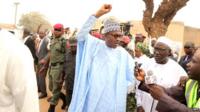 Nigeria's President-elect Muhammadu Buhari gesturing after getting accredited for the Governorship and House of Assembly election in Daura, Katsina State, on 11 April 2015