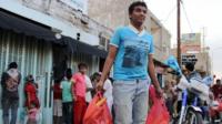 A youth carries bags of bread in the Yemeni city of Taiz