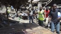 Rescue workers at the site of a bomb attack at a market in Maiduguri , Nigeria, 2 June 2015