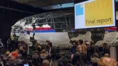 The reconstructed airplane serves as a backdrop during the presentation of the final report into the crash of July 2014 of Malaysia Airlines flight MH17 over Ukraine, in Gilze Rijen, the Netherlands, 13 October 2015