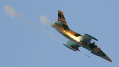 A Syrian Air Force fighter plane firing a rocket during an air strike (file image)