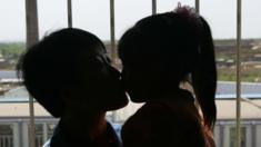 An inmate kisses her daughter during a celebration on Mother's Day at the Jilin Provincial Women's Prison 13 May 2007