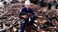 his file photo taken on 8 September 1996 shows Norm Legg, a project supervisor with a local security firm, holding up an armalite rifle which is similar to the one used in the Port Arthur massacre and which was handed in for scrap in Melbourne after Australia banned all automatic and semi-automatic rifles in the aftermath of the Port Arthur shooting